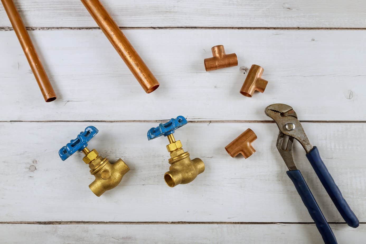 Brass gate valve on wooden background, monkey wrench brass plumbing fittings