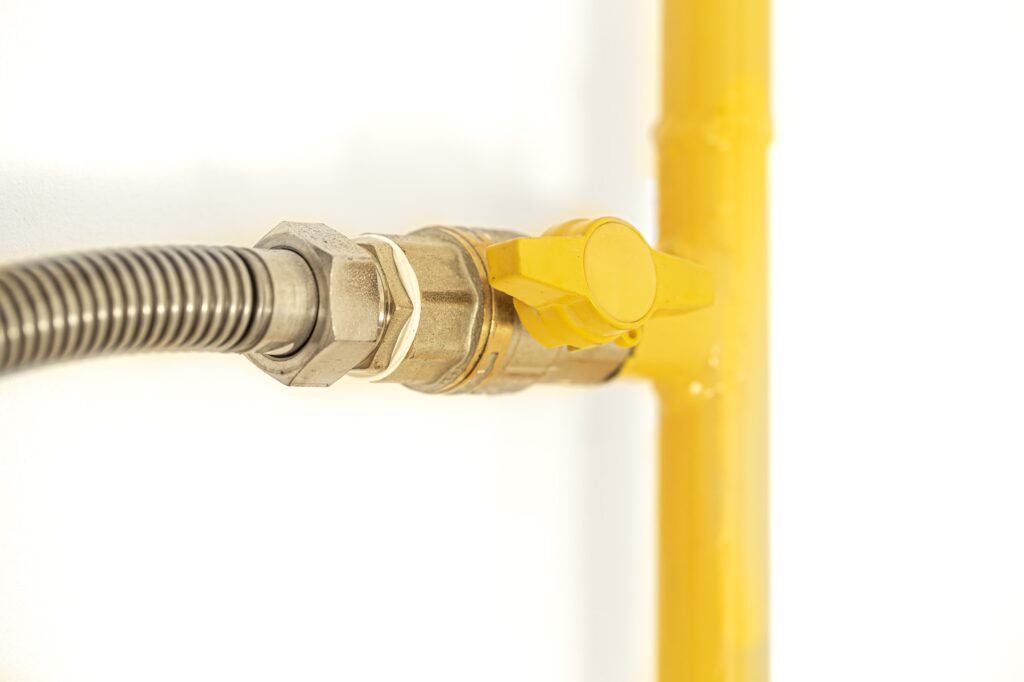 Yellow gas pipe with gas valve.